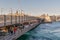 Galata Bridge with traditional fish restaurants along the bridge overlooking Galata Tower in the far distance, Istanbul, Turkey