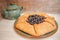 Galeta galette tart cake pie of whole grain flour with blueberries on a white country table with Turquoise color cup with flowers