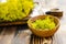 Galium verum, lady bedstraw or yellow bedstraw used in alternative medicine in wooden plate on a vintage table next