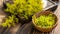 Galium verum, lady bedstraw or yellow bedstraw used in alternative medicine in wooden plate on a vintage table next utting boards