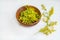 Galium verum, lady bedstraw or yellow bedstraw used in alternative medicine in wooden plate on white table. Medicinal