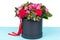 Gallant bouquet of pink and red roses and red ribbon in a circular black box