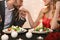 Gallant Man Kissing Hand Of Girlfriend On Romantic Dinner In Restaurant