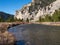 Gallatin River with Autumn Vegetation and Rocky Cliffs