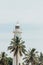 Galle lighthouse with palm trees in sky