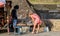 Galle, Sri Lanka - 02 03 2022: Beautiful Caucasian women buy souvenirs from a local seller at Galle Fort, Sri Lanka. Girl bends