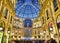 The Galleria Vittorio Emanuele II illuminated by christmas lights and a shinny christmas tree. Milan, Lombardy, Italy