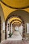 Gallery of arches and colonnade inside the cemetery of San Candido, Italy.