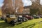 gallery of vintage vehicles on the lawn of stately manor house