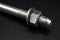 Galvanized steel metal dowel with metric bolt, isolated on black background