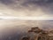 Galway bay, Atlantic ocean, Two sides of the coast. Burren in the background. Dramatic cloudy sky. Aerial view