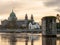 Galway Cathedral at dusk Old stone bridge base in a Corrib river in foreground. Cloudy sky