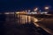 Galway city, Ireland - 25.10.2021: Salthill promenade illuminated at night. Town lights reflection in the ocean water