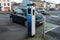 Galway, Ireland - 01.22.2021: ESB electric car charge point in town and BMW hybrid car connected and recharging the battery