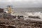 Galway - Ireland 02/28/2020: Blackrock public diving board hit by powerful waves before storm Jorge . Man on top of the board