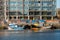 Galway, Ireland - 04.02.2021: Galway port, Small fishing boats in harbor, Bonham quay construction site in the background