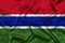 Gambia national flag background with fabric texture. Flag of Gambia waving in the wind. 3D illustration