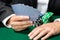 Gambler playing cards with chips on the table