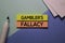 Gambler`s Fallacy text on sticky notes isolated on office desk Concept