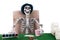 Gambler skeleton play poker with stack of banknote and chips on