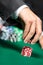 Gambler stakes the pile of poker chips