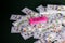 Gambling: Pink eraser with really big mistakes message and scattered and stacked US dollars
