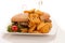 Gamburger with frenchfries on a plate isolated over white background