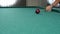 Game of billiards. Close-up of a player hitting a cue in a billiard ball.