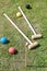 Game of croquet on green lawn