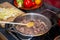 Game goulash in pot with stirring spoon , onion and vegetables