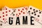Game night text on lightbox with playing cards on yellow background, table games