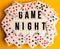 Game night text on lightbox with playing cards on yellow background, table games