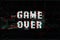 Game Over, screen message, vector illustration. Glitch effect text, digital noise background.