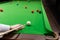 Game snooker billiards, athlete kick cue close up, selective foc