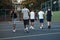 The game is about to start. Rearview shot of a group of sporty young men hanging out on a basketball court.