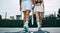 A game well played. two unrecognizable tennis players walking away after a game.