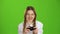 Gamer girl is holding a joystick. Green screen