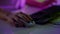 Gamer hands typing keyboard in neon cyberspace closeup. Video gaming club night.