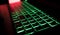 Gamer keyboard with green backlight and red background light.