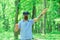 Gamer man wear VR glasses in summer forest. Gamer play virtual reality game with mobile device on fresh air