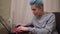 Gamer playing online computer game, smiling, focused on game, blue hair