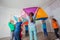 Games with colorful canopy, children sitting under parachute