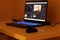 Gaming Laptop With Blue Keyboard. Editing Program On The Display. Blue Bokeh Lights
