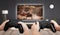 Gaming in living room concept. Two boys holding gamepad and play console game on TV