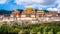 Ganden Sumtseling monastery main buildings scenic view with golden roofs surrounded by green nature Shangri-La Yunnan China