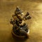 Ganesha bronze figurine over golden background