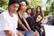 Gang Of Young People In Urban Setting Sitting On Bench