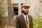 Gangster with a beard and hat near an abandoned building. Retro. Outdoors.