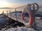 Gangway over the frozen ground and a lifebuoy.