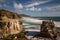 Gannett colony on the rocks above Muriwai Beach on the West coast of New Zealand, long exposure to smooth out the water and give